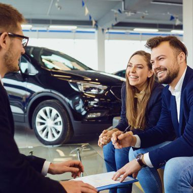 A couple buying a car from a car dealer.