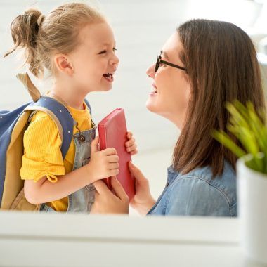 Mother preparing a child for school.